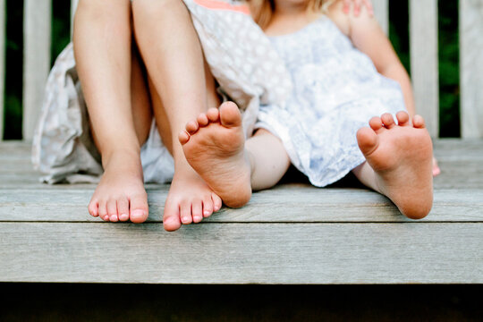 Sisters feet on park bench