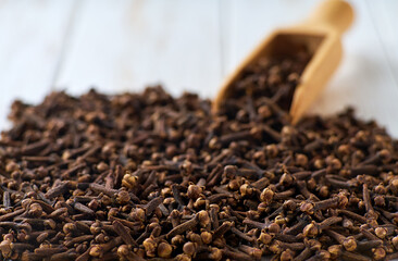 cloves spice on a white wooden table, selective focus.
