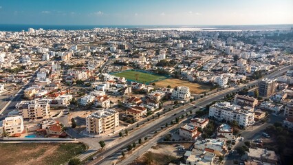 Aerial view of a sprawling urban landscape with residential buildings and roads.