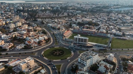 Aerial view of a bustling cityscape with a stadium.