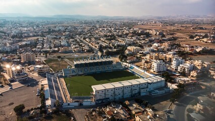Aerial view of a soccer stadium in a bustling cityscape.