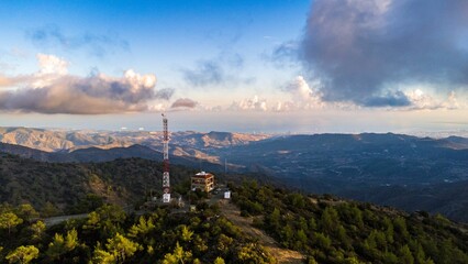 Fototapeta premium Aerial view of a scenic mountainous landscape with a communication tower.