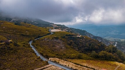 Aerial view of winding road through lush hills.