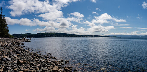 rocks on the shore of the Queen Charlotte Strait blue sky