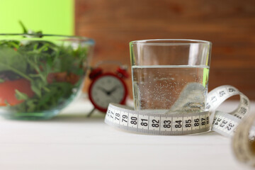 Embracing a Healthy Lifestyle A Fresh Green Apple with a Colorful Salad and Measuring Tape