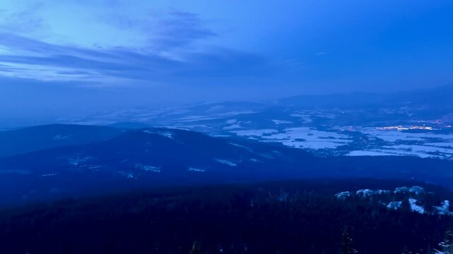 Evening winter landscape of the city and snow-capped mountains from the observation deck. High quality 4k footage