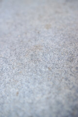 Detailed texture of gray felt fabric, with soft variations and a slightly blurred focus, creating a subtle and versatile background
