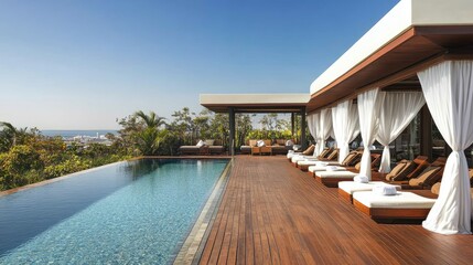 Fototapeta premium A tranquil hotel pool with a wooden deck, featuring cozy cabanas draped with white curtains for a relaxing atmosphere.