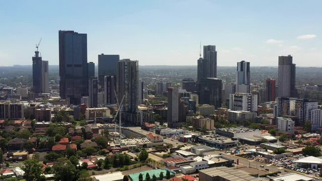 Aerial landing in view of Parramatta city CBD skyline of high-rise towers in Sydney west.
