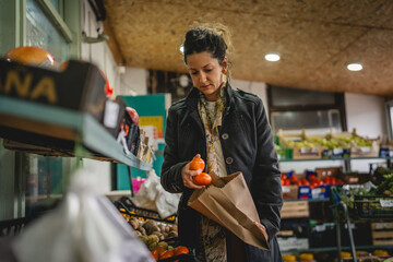 Woman grocery shopping at the local store with paper bag