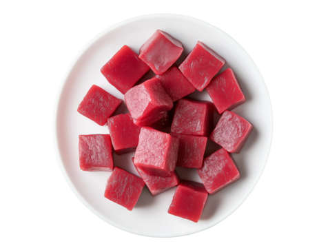 Photograph of raw beef fillet cubes on a plate, top view, against a transparent background PNG 
