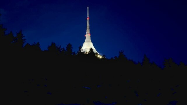 Illuminated futuristic Jested tower in the city of Liberec on top of the mountain at night.. High quality 4k footage