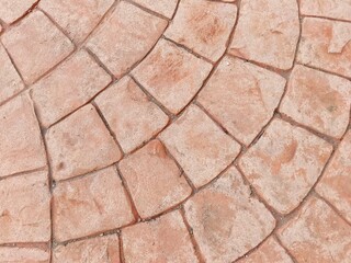 Defocused view of stamped concrete used to create textured pattern on concrete surfaces to resemble materials like brick or stones