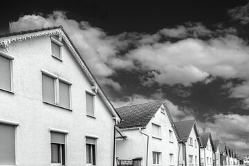 row of houses in similar architectural style as family houses in a urban city