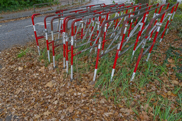 Fototapeta premium Cluster of Red and White Barriers in Autumn Setting