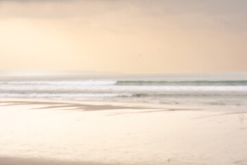 Blurry background of cloudy beach at sunset