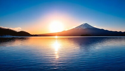 雪を被った冬の富士山と日の出と湖の風景