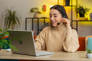 Young woman wearing headset, freelance worker, call center or support service operator helpline,...