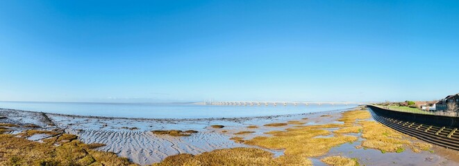 Panoramic coastal view with distant bridge in Severn Beach, Bristol, UK