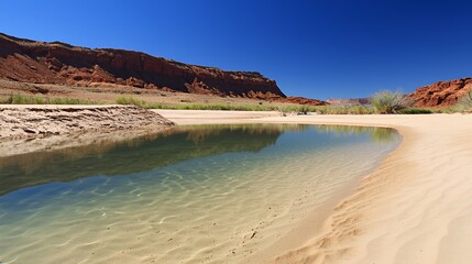 Calm Desert River With Red Rock Canyon Landscape Under Bright Sunlight