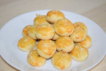 Golden Brown Cookies Piled High On A White Round Plate