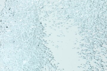 Many water bubbles on light background, closeup