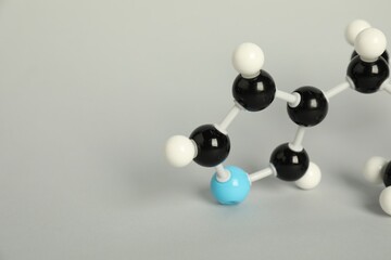 Chemical model of molecule on light grey background, closeup. Space for text