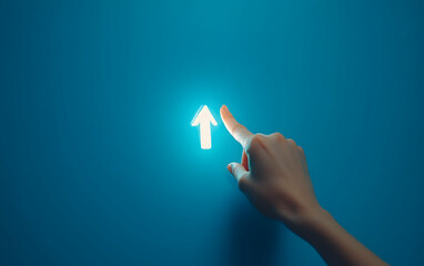 Hand Pointing Towards Illuminated Arrow on a Blue Wall Symbolizing Direction and Innovation