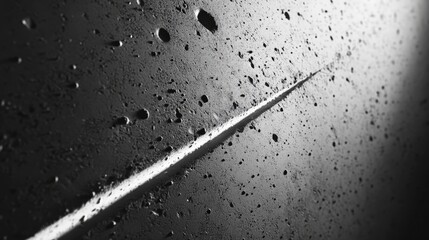 Naklejka premium Moon's cratered surface glistens with scattered water droplets, forming an intricate texture against its stark black-and-white terrain. A mesmerizing close-up of lunar mystique