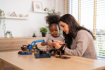 Portrait happy teacher help school children student having fun activity learn training play building toy STEM, education, science, engineering, programming, coding, robot technology class at school