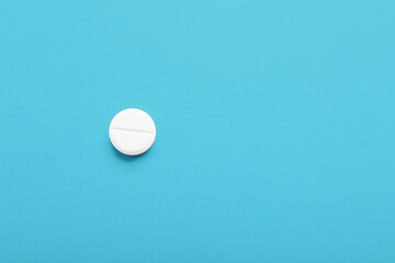 White medical pill on blue background