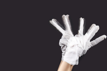 Stroboscopic photo of moving woman showing victory gesture on dark background