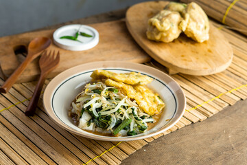 Pecel. Traditional Javanese vegetable salad with sweet and spicy peanut sauce; served with white rice, fried tempeh, and stuffed fried tofu.
