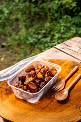 Delicious sweet dried dates in transparent plastic box, popular dried dates fruit during Ramadan