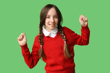 Happy schoolgirl on green background