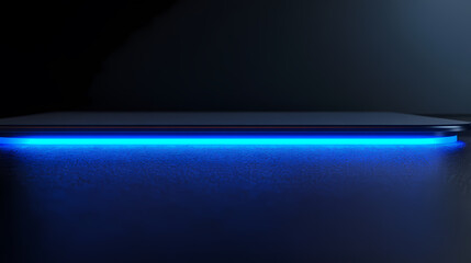 Blue glowing tablet on black desk
