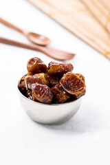 Delicious dried dates, popular fruit dates during the month of Ramadan in a silver bowl