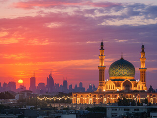 Fototapeta premium Mosque at Sunset with Vibrant Sky and Reflection