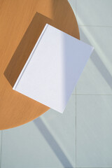 book cover mockup design. blank book mockup on wooden coffee table , shadow overlay