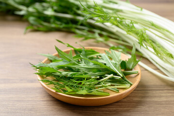 Mizuna, Water green, Japanese mustard green or spider mustard on wooden plate