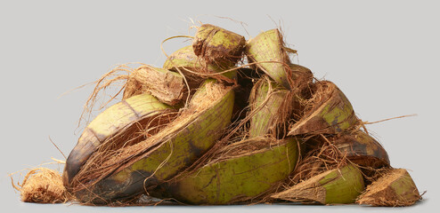pile of freshly removed coconut husk or coir in close-up isolated white background, outer husk of...