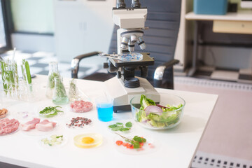 A food scientist analyzes food samples, plants, vegetables, and meat using a microscope and laboratory equipment to ensure safety, quality, and innovation in food science and technology