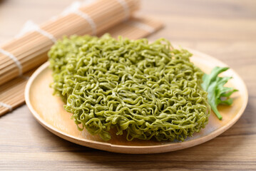 Instant green noodles on wooden plate, Asian food