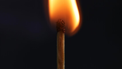 Burning matchstick in dark, representing life
