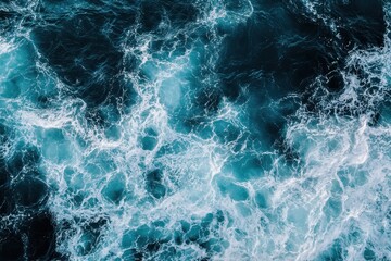 Fototapeta premium Aerial view of churning turquoise sea water with foamy waves