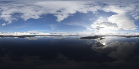 Snow-Capped Mountains Reflected in a Lake Under a Blue Sky Panorama