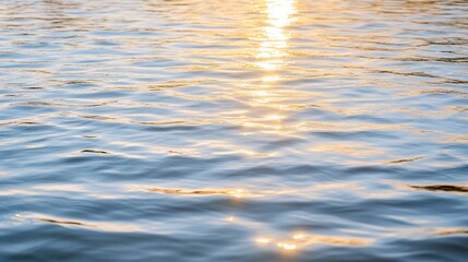 Golden sunset reflecting on calm lake water