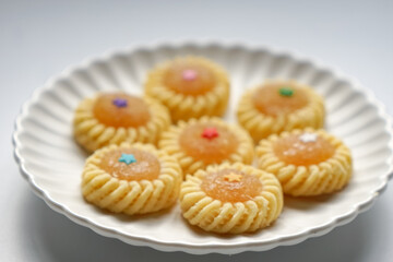 Pineapple Tart or Tart Nenas, a popular cookie in Malaysia during celebration of Eid Mubarak (Hari Raya) isolated on white background with some shadow and selective focus.