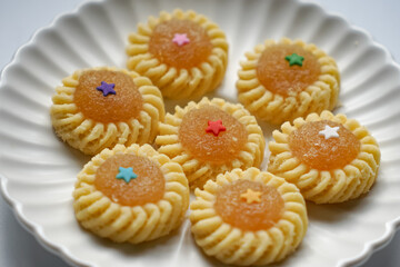 Pineapple Tart or Tart Nenas, a popular cookie in Malaysia during celebration of Eid Mubarak (Hari Raya) isolated on white background with some shadow and selective focus.