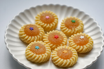 Pineapple Tart or Tart Nenas, a popular cookie in Malaysia during celebration of Eid Mubarak (Hari Raya) isolated on white background with some shadow and selective focus.